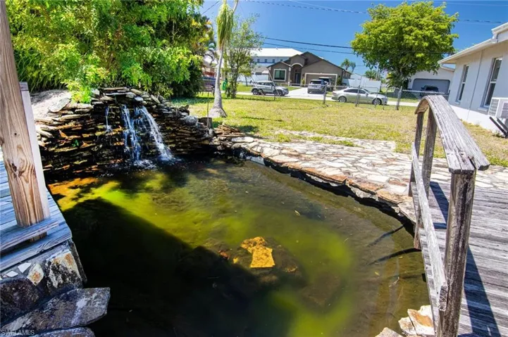 Pond with running waterfall feature