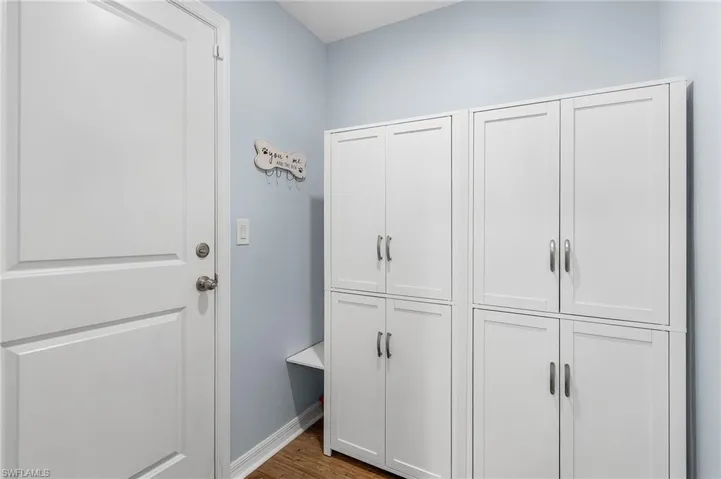 Laundry room or panty (washer dryer hookup behind cabinets)