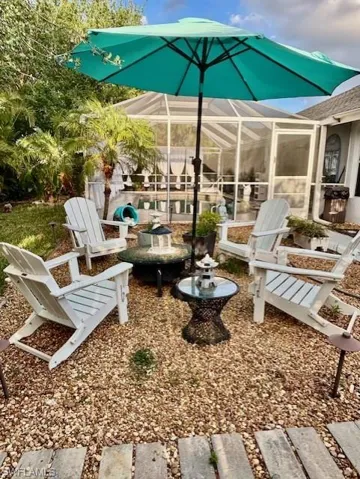 View of patio featuring a sunroom
