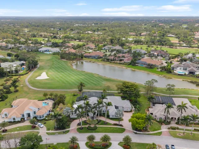 Drone / aerial view featuring view of golf course, a residential view, and a water view