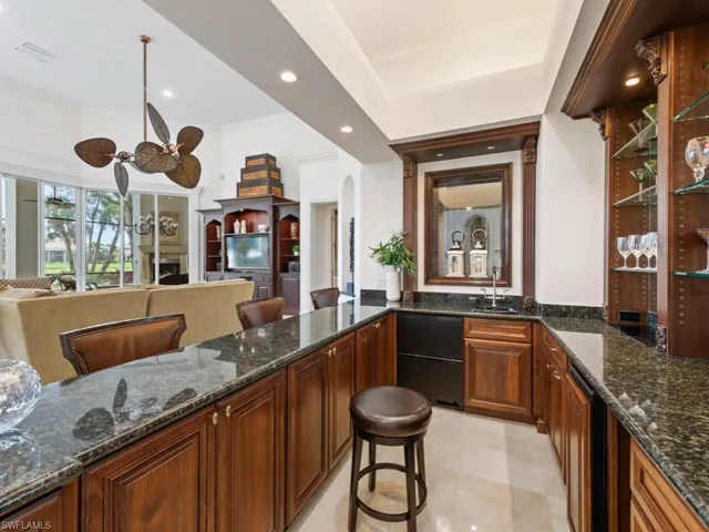Bar featuring recessed lighting, ornamental molding, a sink, arched walkways, and visible vents