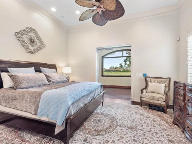 Bedroom featuring crown molding, recessed lighting, baseboards, a ceiling fan, and wood finished floors