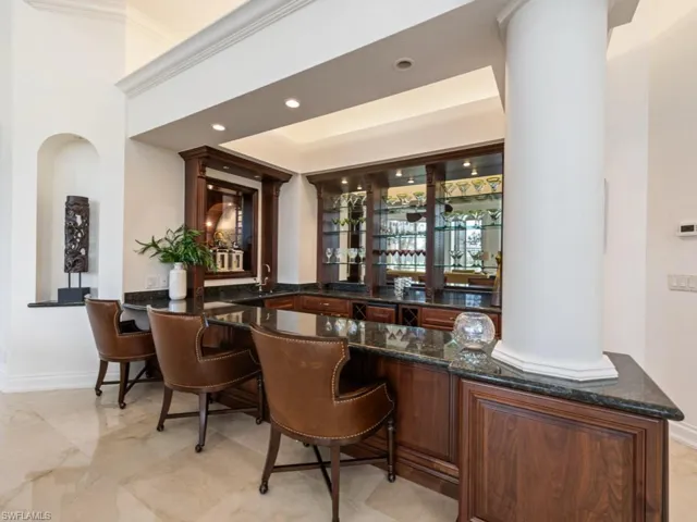 Bar with a sink, baseboards, indoor wet bar, and recessed lighting