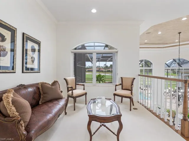 Living area featuring plenty of natural light, ornamental molding, carpet floors, and recessed lighting