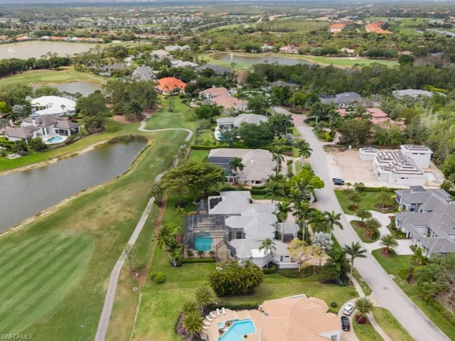 Aerial view featuring view of golf course, a residential view, and a water view