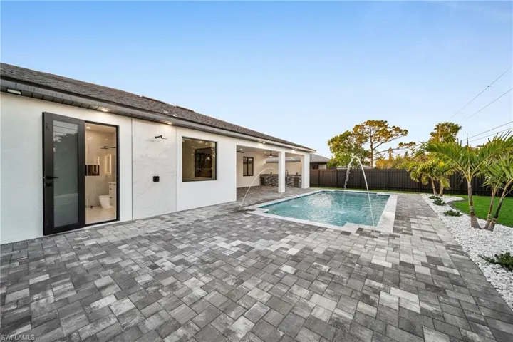 View of swimming pool featuring a ceiling fan, a fenced backyard, a fenced in pool, and a patio