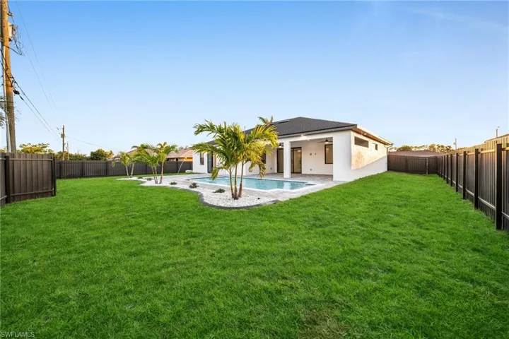 View of yard featuring a fenced in pool, a fenced backyard, and a patio area