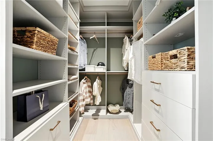 Spacious walk in with custom cabinetry - virtually edited image