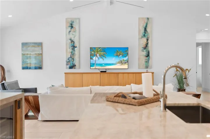 Living room with sink and vaulted ceiling