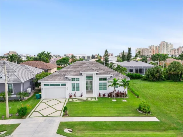 View of front of home with a front lawn and a garage