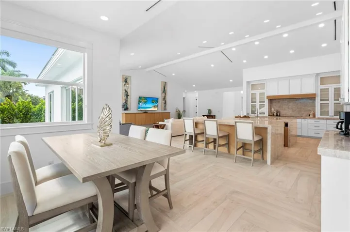 Dining room featuring vaulted ceiling and light parquet floors