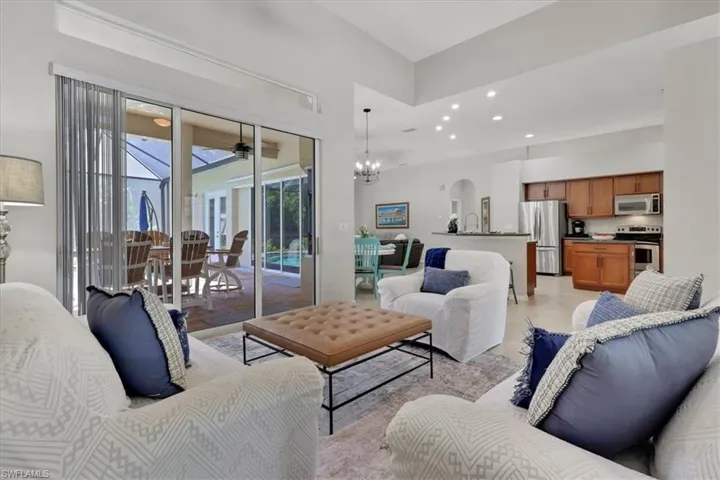 Living area with recessed lighting, a sunroom, and a chandelier