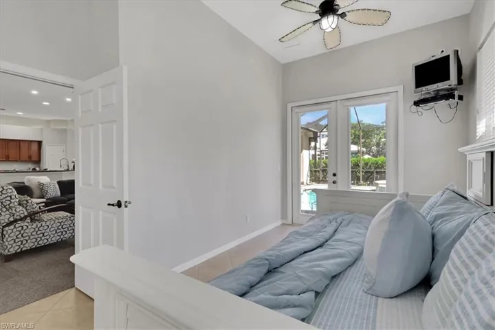 Bedroom with light tile patterned floors, access to exterior, light carpet, ceiling fan, and french doors