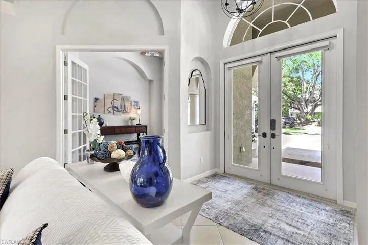Entryway featuring french doors and light tile patterned floors