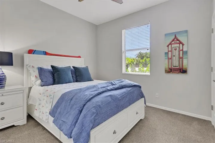 Bedroom featuring light carpet and a ceiling fan