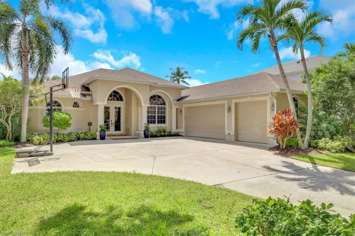 Mediterranean / spanish-style house featuring french doors, driveway, stucco siding, and a garage