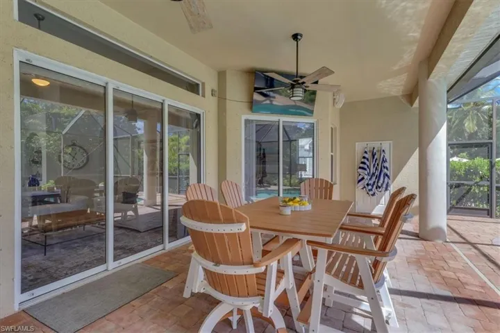 Sunroom featuring a patio, ceiling fan, and outdoor dining space