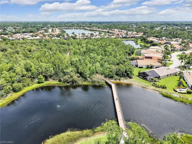 Aerial view of residential area featuring a nearby body of water
