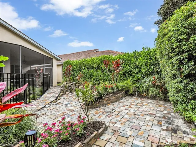 View of patio with a sunroom