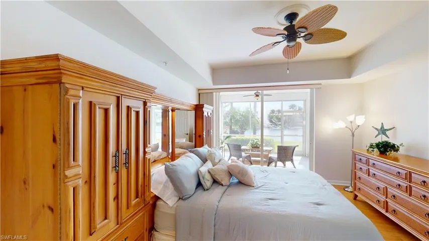 Bedroom with light wood-type flooring, access to outside, and ceiling fan