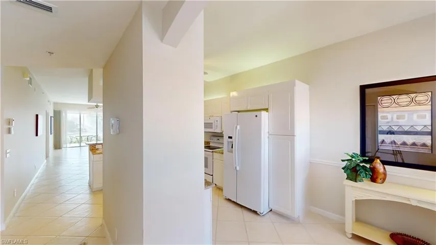 Corridor featuring light tile patterned floors