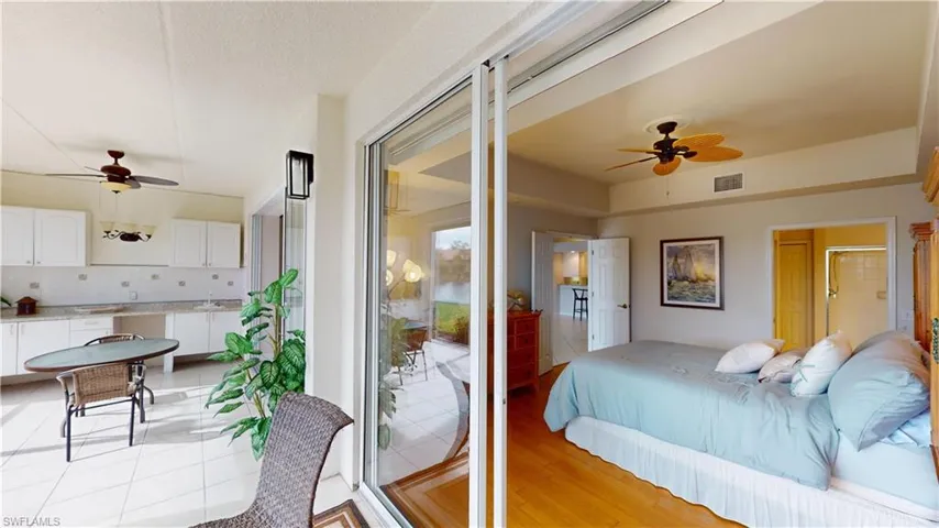 Bedroom featuring access to exterior, light hardwood / wood-style floors, sink, and ceiling fan