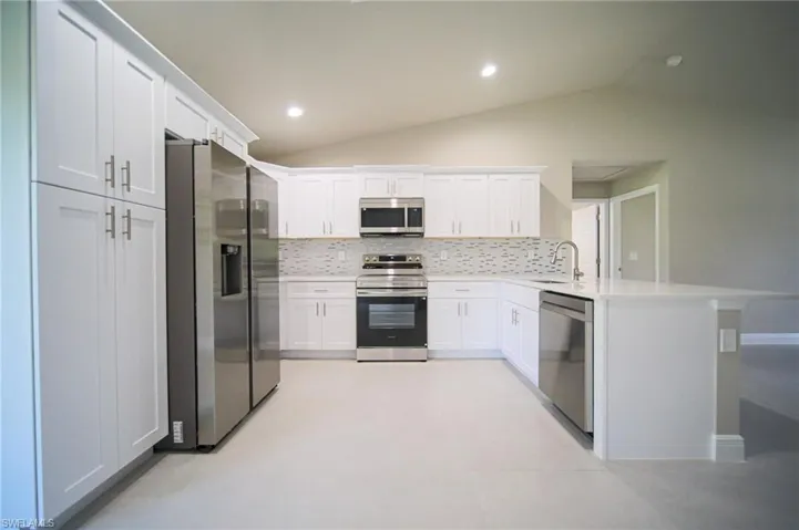 This Amazing Kitchen Features Quartz Countertops, Glass Tile Backsplash, Stainless Steel Appliances, White Real Wood Soft Closing Cabinets And Drawers, A Peninsula That Seats 3 People, Glass Back Door For Plenty Of Natural Lighting, And A Ceiling To Floor Pantry!