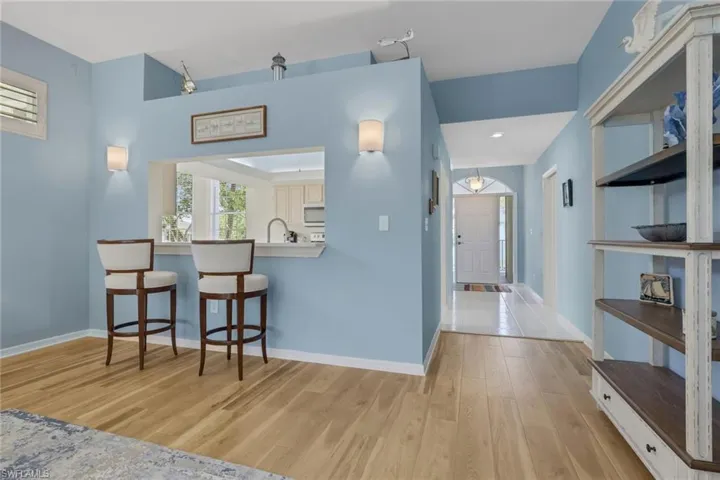 Living roomwith  light wood-style floors looking to front door