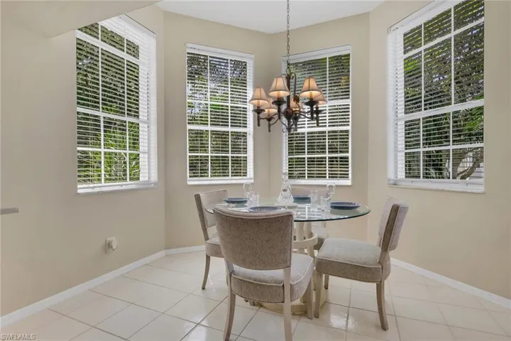 Dining area featuring suspended lighting and light tile patterned floors