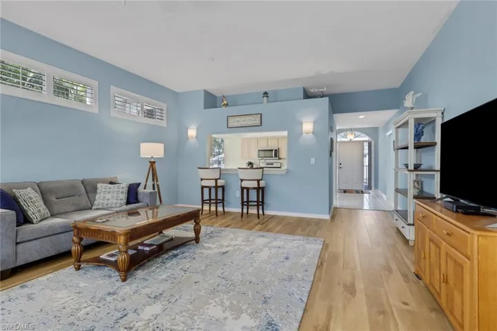 Living area featuring light wood-style flooring and baseboards