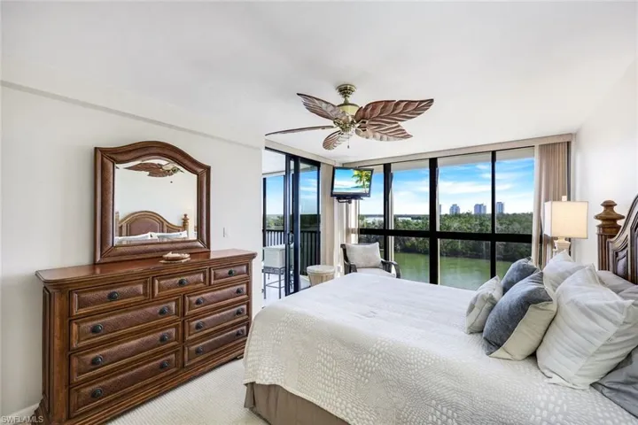 Bedroom with carpet floor to ceiling windows, ceiling fan