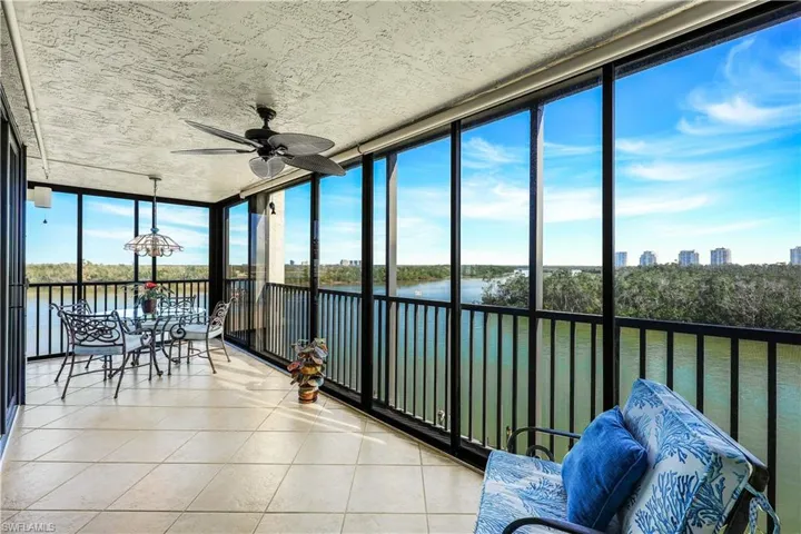 Water Views - floor to ceiling windows, a water view, tile patterned flooring, and a textured ceiling