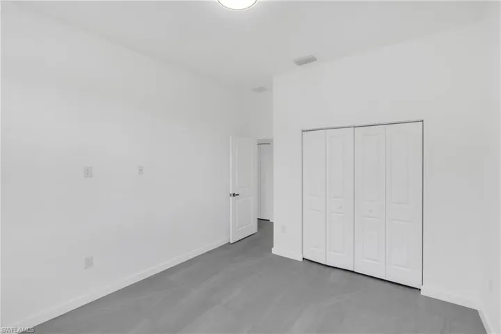 Unfurnished bedroom featuring baseboards and a closet