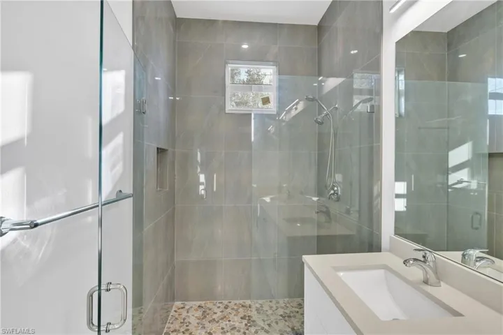 Full bathroom with vanity and a stall shower