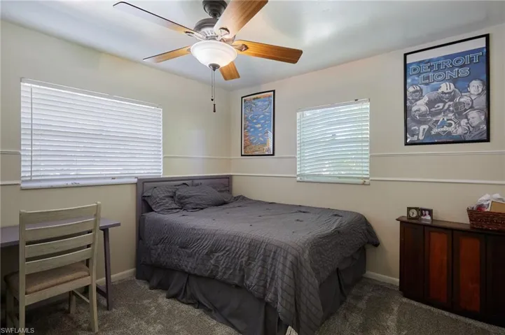 Carpeted bedroom with baseboards and ceiling fan