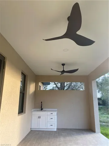 View of patio featuring ceiling fan and sink