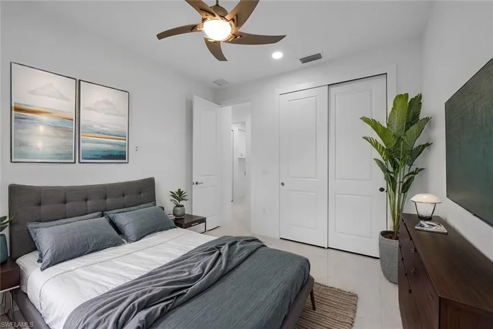 Bedroom featuring ceiling fan and a closet