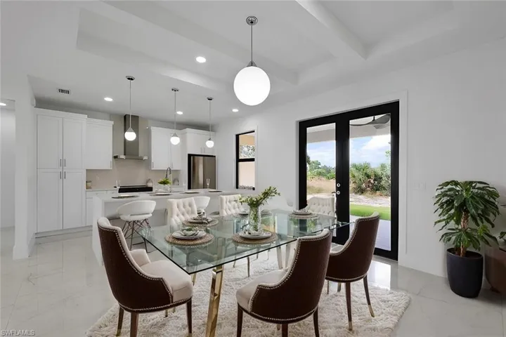 Dining space with beam ceiling and french doors