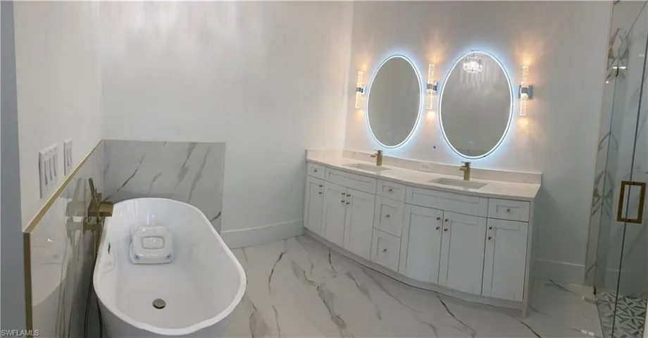 Bathroom featuring vanity and a bathing tub