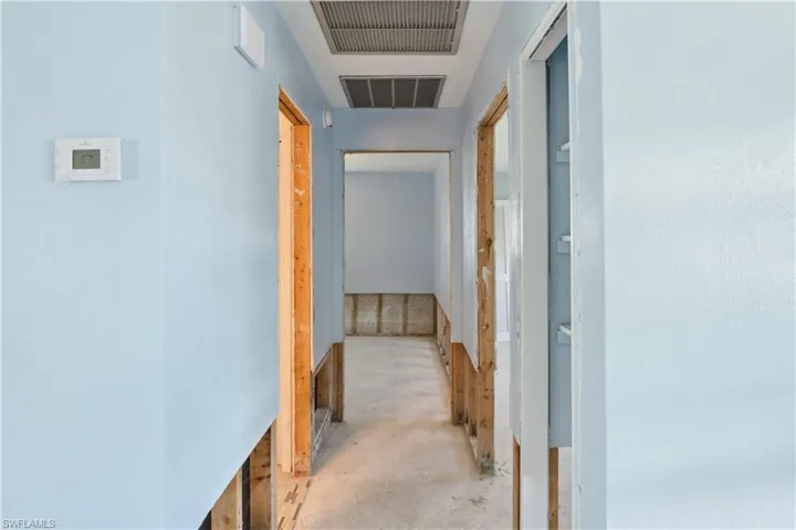 Hallway to bedrooms and 1 full bathroom. Bathroom on left, bedroom on right, and 2nd bedroom straight ahead