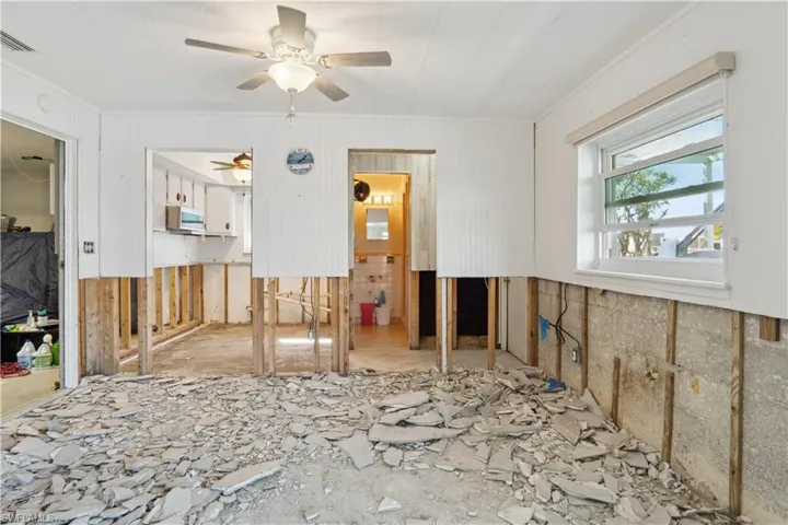 dining room area. kitchen on left and 2nd bathroom/pool bathroom on right