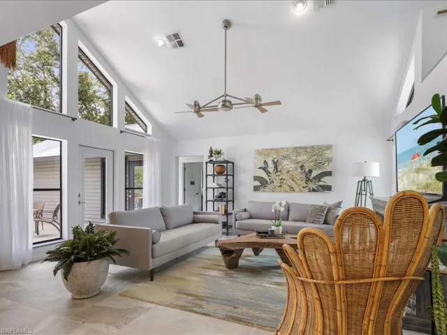 Living room with high vaulted ceiling and double ceiling fan