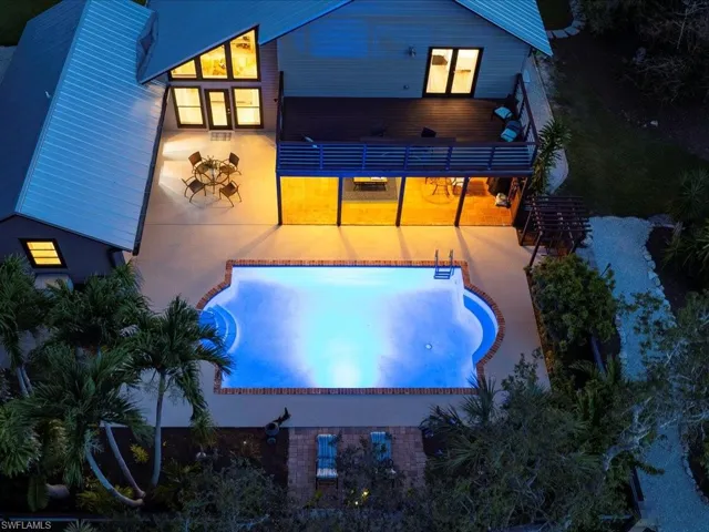Back of property featuring an outdoor pool and a patio