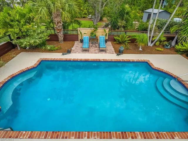 Outdoor pool featuring a patio and a fenced courtyard