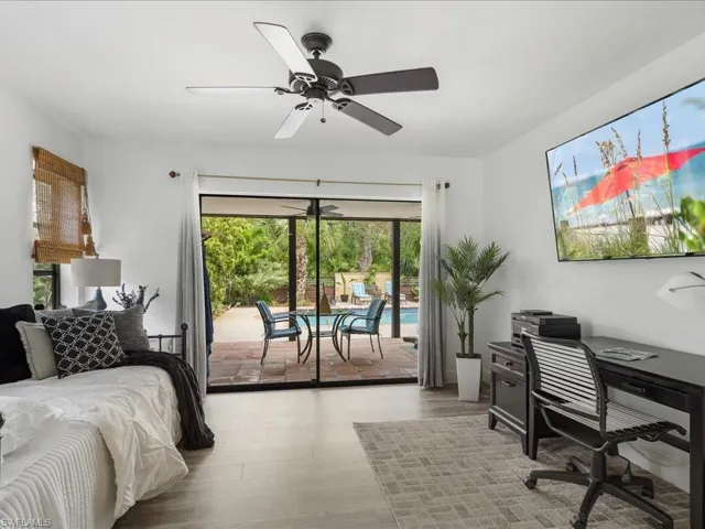 Bedroom with access to exterior, a desk, LVP floors, and a ceiling fan