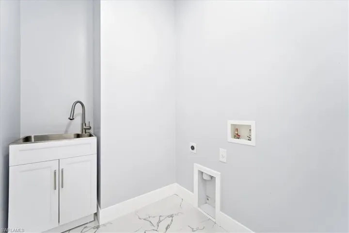 Laundry room featuring light marble finish flooring, electric dryer hookup, and hookup for a washing machine