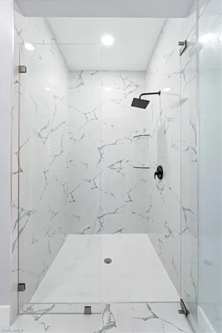 Full bathroom featuring a marble finish shower