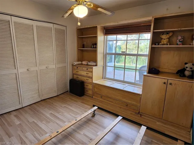 Unfurnished bedroom featuring light hardwood / wood-style floors, a closet, and ceiling fan