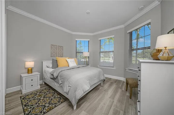 Guest bedroom (Bedroom #2) features crown molding and lots of windows offering an abundance of natural light.