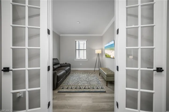 French doors leading to flex room which can be utilized as a home office or additional bedroom or den.